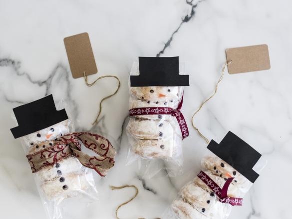 Baked pumpkin doughnuts with snowman icing