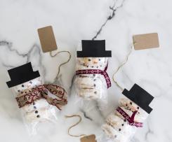 Baked pumpkin doughnuts with snowman icing