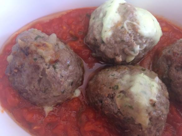 Cheese filled meatballs in tomato sauce