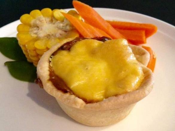 Polenta topped braised beef cheek pies