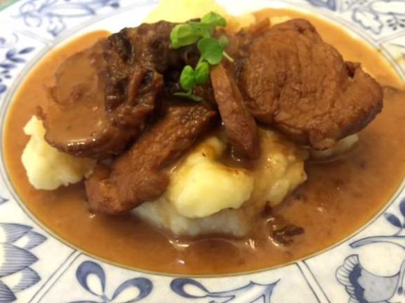 Pork with creamy sauce on mashed potatoes