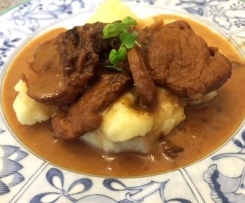 Pork with creamy sauce on mashed potatoes