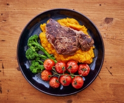 Beef with pumpkin mash, steamed vine tomatoes and broccolini